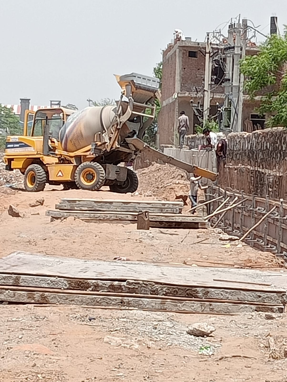 Indian Railways site work with concrete placement near railway tracks