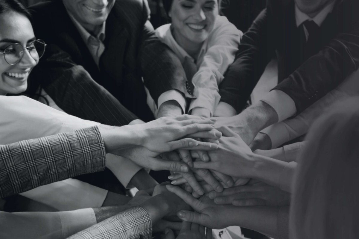 Team placing hands together in collaboration